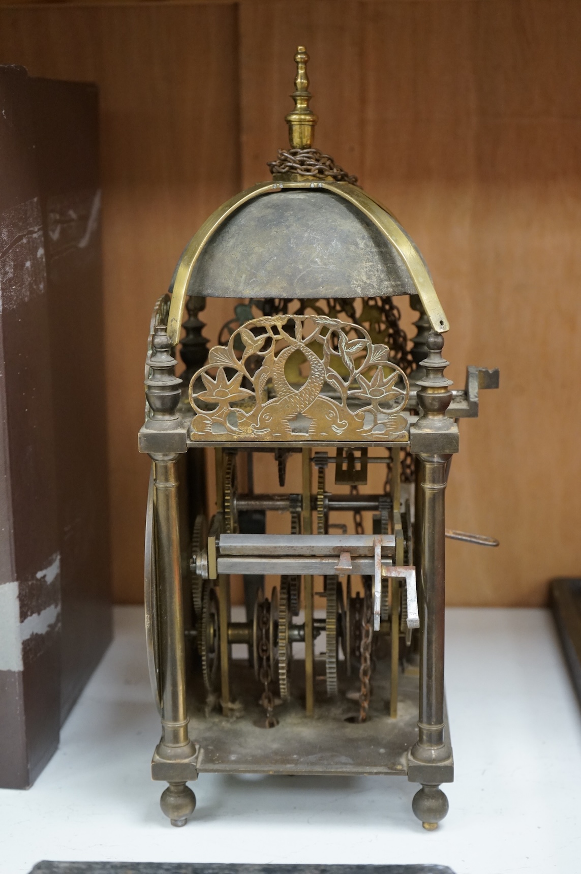 An 18th century lantern clock with pendulum and weight, the dial inscribed Philip Wardale, 37cm high